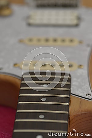 Wood color electric guitar with pearl white pickguard Stock Photo