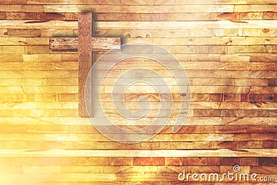 Wood cross on wooden background in church with ray of light Stock Photo