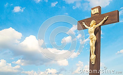 Wood crucifix the body of Christ on the cross on the blue sky cl Stock Photo