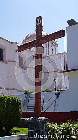 Wood crux outside of a church in mexico Stock Photo