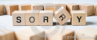 Wood cube block with word SORRY on white table Stock Photo