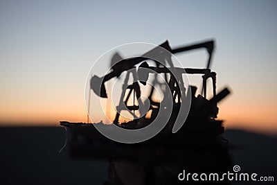 Wood Decoration. Oil pump oil rig energy industrial machine for petroleum in the sunset background for design Stock Photo