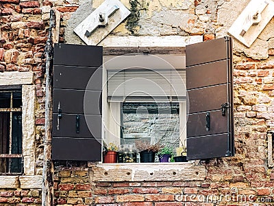 Wood door and window. On redbrick wall, building facade in Venice, exterior design Stock Photo