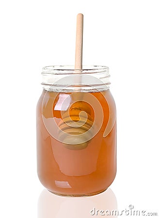 Wood Drizzler In Jar Of Honey, Isolated Stock Photo