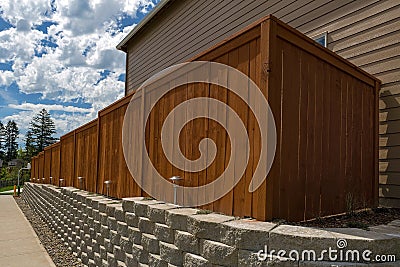 Wood Fence and Cement Blocks Retaining Wall Stock Photo