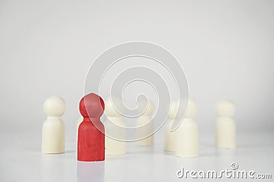 Wood figure of a man in red, symbol of leadership Stock Photo