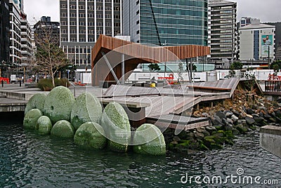 Modern North Kumutoto Pavilion on coastal decked square, and waterfront artwork of Nga Kina shells in Wellington CBD, New Zealand Editorial Stock Photo