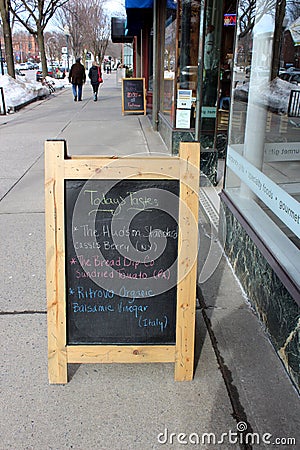 Large wood framed chalkboards line the streets of downtown area, advertising sales for people passing by, saratoga, New York, 2019 Editorial Stock Photo