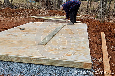 The wood framing beams that make up the stick framework of the shed deck foundation are made from hardwood Stock Photo