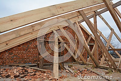 Wood framing during the roofing construction.Timber trusses, roof framing with a close-up of roof beams, struts and rafters Stock Photo