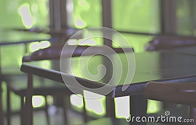 Desk, empty wooden chairs in the shop, outdoor light background, natural green Brightness from the outside Stock Photo