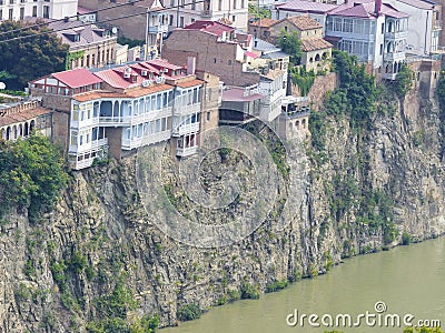 Wood houses to a cliff above the river to Tbilissi in Georgia. Editorial Stock Photo