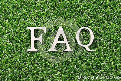 Wood letter in word FAQ Abbreviation of Frequently asked questions on green grass background Stock Photo