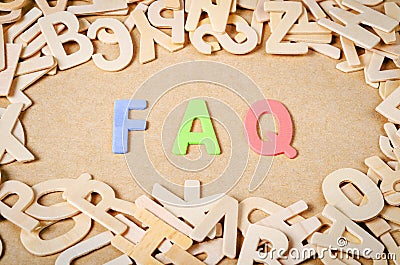 Wood letters as FAQ abbreviation. Stock Photo