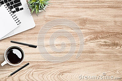 Wood office desk table with laptop, cup of coffee and supplies. Top view with copy space, flat lay Stock Photo