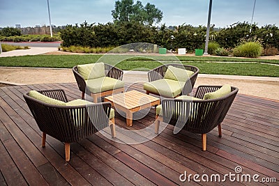 Wood patio lounge chairs with green cushions Stock Photo