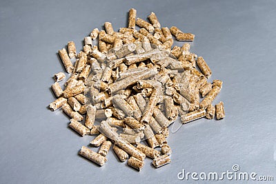 Wood pellets on a silver background. Biofuels. The Cat Litter Stock Photo