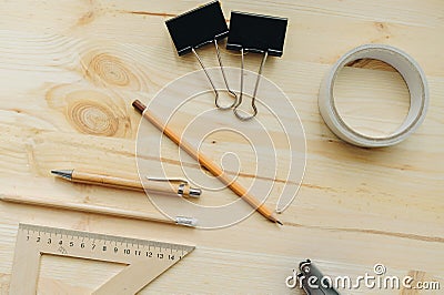 Wood pencil, pen, triangle, briefpapier clips, hefter on the desk in daylight. Office table Stock Photo