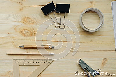 Wood pencil, pen, triangle, briefpapier clips, hefter on the desk in daylight. Office table Stock Photo