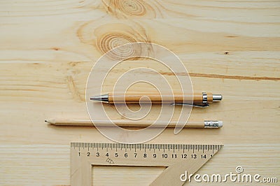 Wood pencil, pen, triangle on the desk in daylight Stock Photo