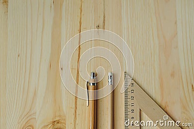 Wood pencil, pen, triangle on the desk in daylight Stock Photo