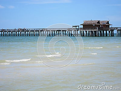 Wood pier by beach in Naples Florida Stock Photo