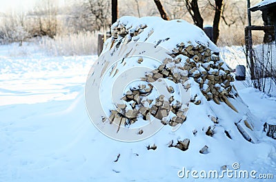 Wood pile covered with snow Stock Photo