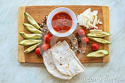 Wood plate with food, on a white table Stock Photo