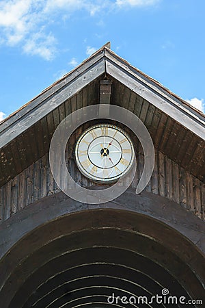 Wood roof arcade with old roman golden numbers clock showing 13:25 Stock Photo