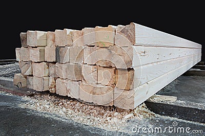 Wood at the sawmill. Lumber is stored in the warehouse Stock Photo