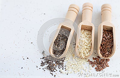Wood scoops with white sesame, flax and chia seeds Stock Photo