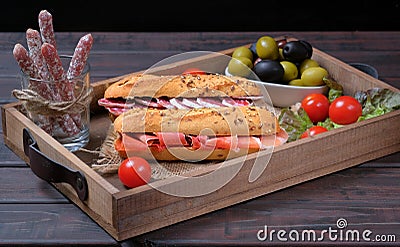 Wood serving or kitchen tray with traditional Spanish ham sandwiches Stock Photo