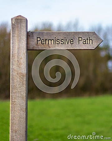 Wood sign marking the permissive path Stock Photo