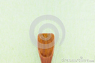 Wood spoon on green strip tablecloth,Leave space for adding your Stock Photo