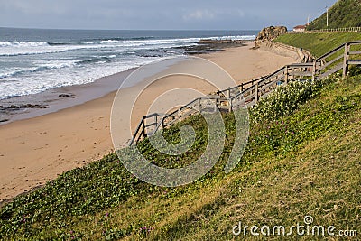 Wood Stairway above Vegetation Leading onto Beach Stock Photo