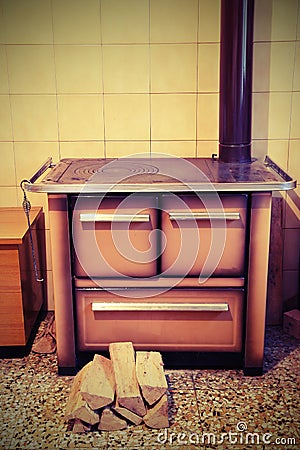 Wood stove in a kitchenette of an old mountain house Stock Photo