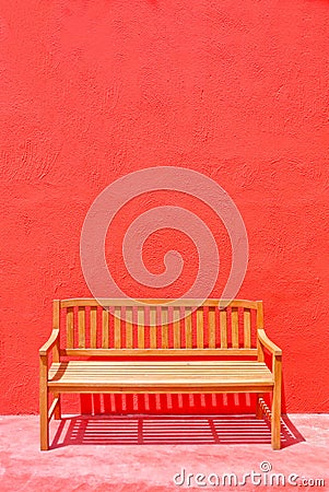 Wood street chair over the red wall Stock Photo