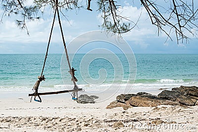 Wood swing and beautiful beach. Stock Photo