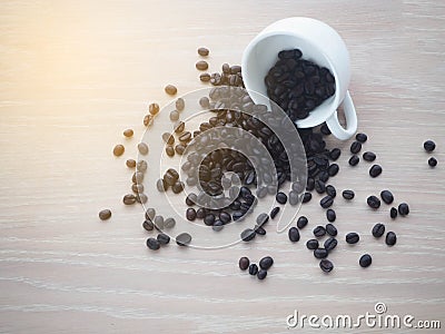 Wood table with black coffee cup and coffee bean. Stock Photo