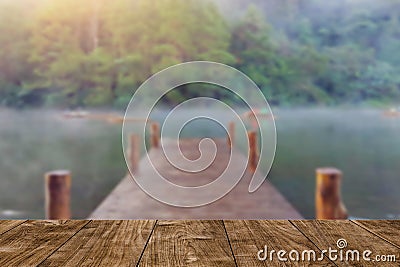 Wood table with blur wood bridge dock lake travel background Stock Photo