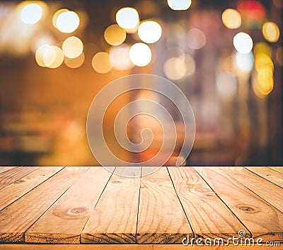 Wood table top Bar with blur light bokeh in dark night cafe,restaurant background Stock Photo