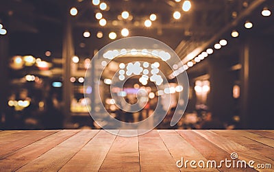 Wood table top Bar with blur light bokeh in dark night cafe Stock Photo