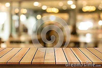 Wood table top on blur bokeh cafe background can be used for dis Stock Photo