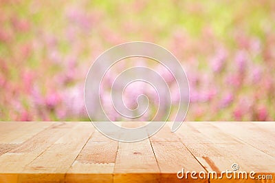 Wood table top on blur flower garden background Stock Photo