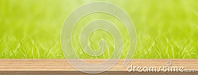 Wood table top and blur green grass for product and display montage banner size. Stock Photo