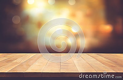 Wood table top with blur light bokeh in night cafe background Stock Photo