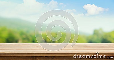 Wood table top on blur tree and mountain background Stock Photo