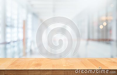 Wood table top on blur white glass wall background form office building Stock Photo