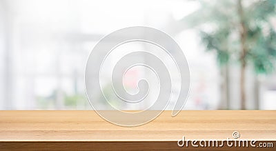 Wood table top on blur white glass wall background form office building Stock Photo