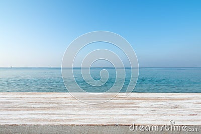 Wood table top on blurred blue sea and white sand beach background Stock Photo